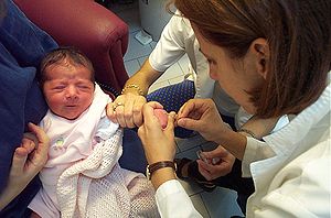 Un pédiatre effectuant un prélèvement sanguin sur un nourrisson