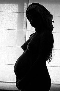 Pregnant woman in the shadows (BW image)