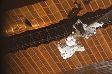 While anchored on the end of the Orbiter Boom Sensor System during STS-120, astronaut Scott Parazynski performs makeshift repairs to a US solar array that damaged itself when unfolding STS-120 EVA Scott Parazynski.jpg