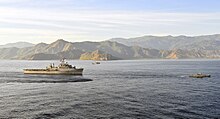 USS Cleveland near the transition between the two straits in 2011, with Cape Fatucama behind her