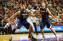 Mike Scott and Joe Harris of the Virginia Cavaliers battle Cadarian Raines of the Virginia Tech Hokies for a rebound in a college basketball game at Cassell Coliseum in Blacksburg. VT - UVA 2012 - Waiting for the rebound.jpg