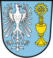 Gemeinde Wattendorf In Blau vorne ein nach links sehender silberner Adler; hinten ein goldener Kelch, aus dem ein goldener Abtstab wächst.[31]
