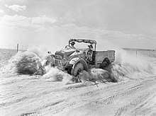 A British Army CMP truck in North Africa, November 1940. Most CMP trucks were produced in Canada during the war. A British Army 15-cwt truck throws up a cloud of sand and dust while moving at speed along a desert track in North Africa, 1 November 1940. E974.jpg