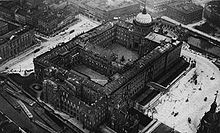 Berlin City Castle with the house An der Stechbahn #3-4 right in the midst of the top edge of the photo, the four-storied building, with wide arched windows on the third floor, housed the Bureau Gruber. Berlin Stadtschloss Luftaufnahme.jpg