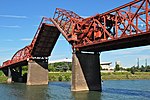 Red metal bridge with draw bridge section raised