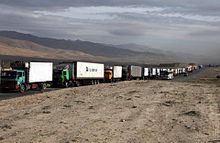 A convoy of civilian trucks waiting for security forces to secure a stretch of road in Afghanistan Convoy of trucks in Afghanistan.jpg