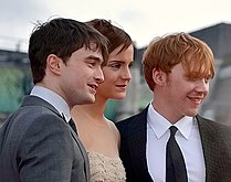 Watson with Daniel Radcliffe (left) and Rupert Grint at the London premiere of Deathly Hallows â€“ Part 2 in July 2011