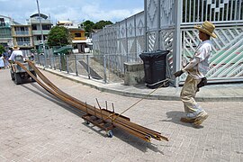 Transporting steel rebar using a village vehicle.