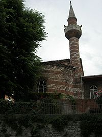 The Apse of the Mosque with the Minaret seen from the north. From here, the alternate courses of bricks and stone are clearly visible.