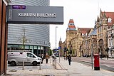 Looking South down the Oxford Road past University place and the Kilburn building sign