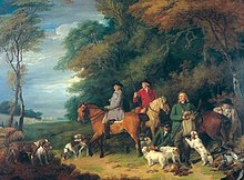 Пятеро мужчин и три лошади на опушке леса вместе с большой группой собак.
