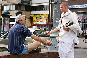 A member of the International Society for Krishna Consciousness proselytising on the streets of Moscow, Russia Russian Hare Krishna Devotee on Sankirtan.jpg