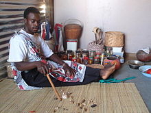 Sangoma performing a divination by reading the bones after being thrown Sangoma reading the Bones.jpg