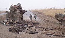 A Stryker lies on its side following a buried IED blast in Iraq. (2007) Size0-army mil-44434-2009-07-10-090719.jpg