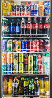 The freedom of choice on which brand and flavor of soda to buy is related to market competition Soft drink shelf 2.jpg
