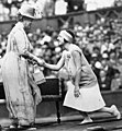 The French tennis player Suzanne Lenglen shakes hands with Queen Mary at the Auteuil Hippodrome in 1926.