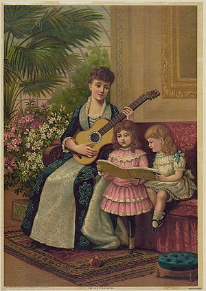 A mother plays the guitar while her two daught...