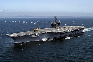 ВМС США 050517-N-0120R-127 Авианосец с обычными двигателями USS Kitty Hawk (CV 63) проплывает мимо небольшой группы японских рыболовных судов и направляется в сторону залива Сагами.