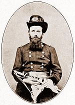 This is an early black and white photo during the Civil War showing Grant with a long beard. Grant looks eager for a battle holding a sword wearing a military uniform with hat.