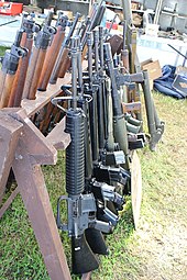 A variety of firearms from the World War II and postwar eras on a firearm rack Victory Show Cosby UK 06-09-2015 WW2 re-enactment Trade stalls Militaria personal gear replicas reprod.originals zaphad1 Flickr CCBY2.0 Misc. machine guns weapons etc IMG 3874.jpg