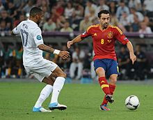 Yann M'Vila and Xavi Spain-France Euro 2012.jpg