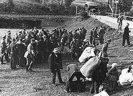 Action Saybusch, 24 September 1940. Expelled Poles await transport at a railway crossing (in this photo, some members of the 129 families deported from the village of Dolna Sol). Aktion Saybusch 1940.jpg