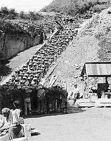 The Todesstiege ("Stairs of Death") at the Mauthausen concentration camp quarry in Upper Austria. Inmates were forced to carry heavy rocks up the stairs. In their severely weakened state, few prisoners could cope with this back-breaking labour for long. Bundesarchiv Bild 192-269, KZ Mauthausen, Haftlinge im Steinbruch.jpg