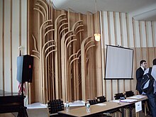 The birch rods on the walls of the Kaufmann Conference Center, retracted during an event Edgar J Kaufmann Conference Room.jpg