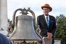 Frederick Douglass IV and a bronze bell at the Lincoln Memorial