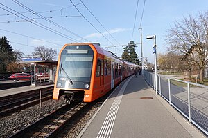 Orange train next to side platform