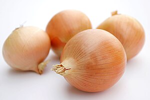 Onions on a neutral, mostly white background