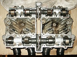 Overhead view of Suzuki GS550 head showing dual camshafts and drive sprockets.