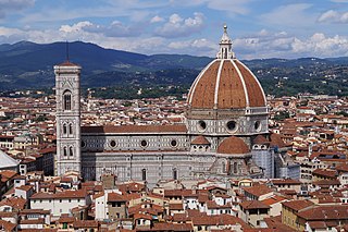 View of Florence showing the dome, which dominates everything around it. It is octagonal in plan and ovoid in section. It has wide ribs rising to the apex with red tiles in between and a marble lantern on top.