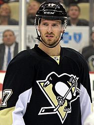 Blake Comeau in a black and yellow Pittsburgh Penguins uniform and black helmet