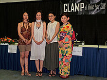 A picture of four Japanese women at a comic convention.