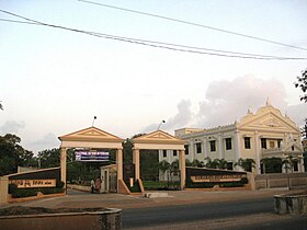 Two gateways next to white building