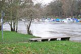 View across the river from the Ham side, showing the wooden jetty and the private boats moored at the boathouse on the north bank