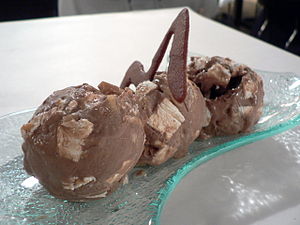 Three scoops of rocky road ice cream, with a c...