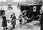 Red Cross workers remove a flu victim in St. Louis, Missouri (1918)