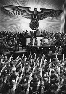 Members of the Reichstag salute Adolf Hitler, dictator of Nazi Germany from 1933 to 1945 Bundesarchiv Bild 183-B06275, Berlin, Reichstagssitzung, Rede Adolf Hitler.jpg