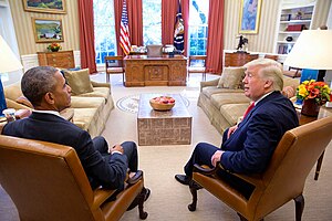 JANUS-Tete-a-Tete- Sitting President & President-elect, Barack Obama & Donald Trump squatting next to each other on arm-chairs in the Oval Office on November 10th 2016. (31196987133).jpg