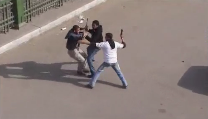 File:Police in civilian cloth beating a protester in Cairo 1.png