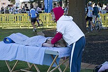 Massage therapist working at a Triathlon in  Fremantle, Western Australia, Australia.