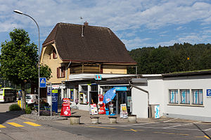 Three-story building and a kiosk next to the station