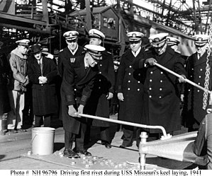 Driving the first or "golden" rivet during USS Missouri's keel laying, 1941 H96796.jpg