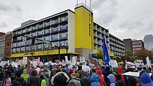 Photograph of a crowd of people outside a building