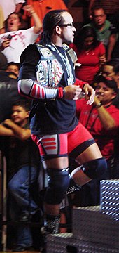 MVP as both the United States Champion (right shoulder) and one half of the WWE Tag Team Champion (left shoulder) in 2007 PorterDuoChamp.jpg