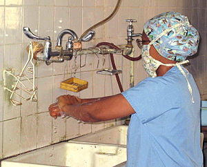A doctor scrubs in for surgery at ECWA Evangel...