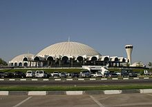 Air traffic control tower in the shape of a cone, Sharjah Airport. Sharjah - International (SHJ - OMSJ) AN0609523.jpg