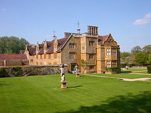 exterior of country house of Tudor period surrounded by extensive lawns